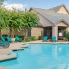 a swimming pool in front of a clubhouse